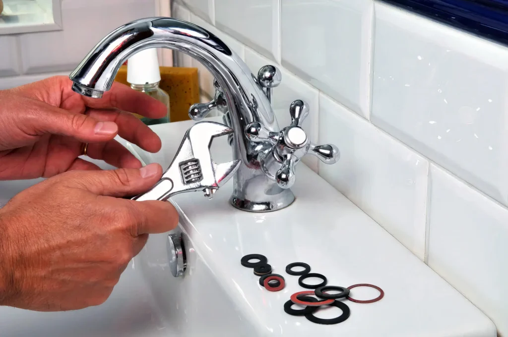 Plumber performing maintenance on a bathroom faucet in Marina
