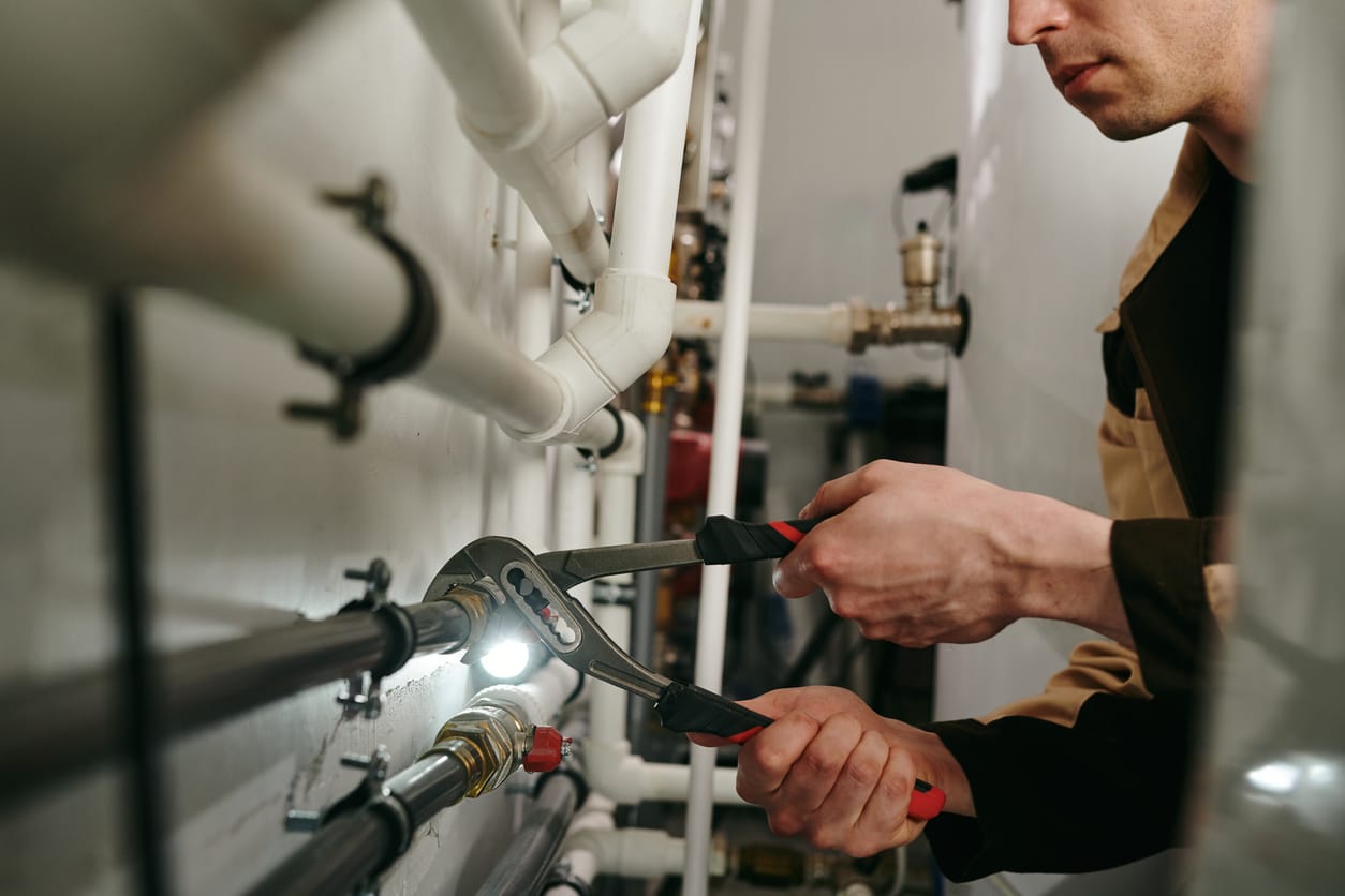 Plumbers maintaining commercial plumbing pipes in Marina