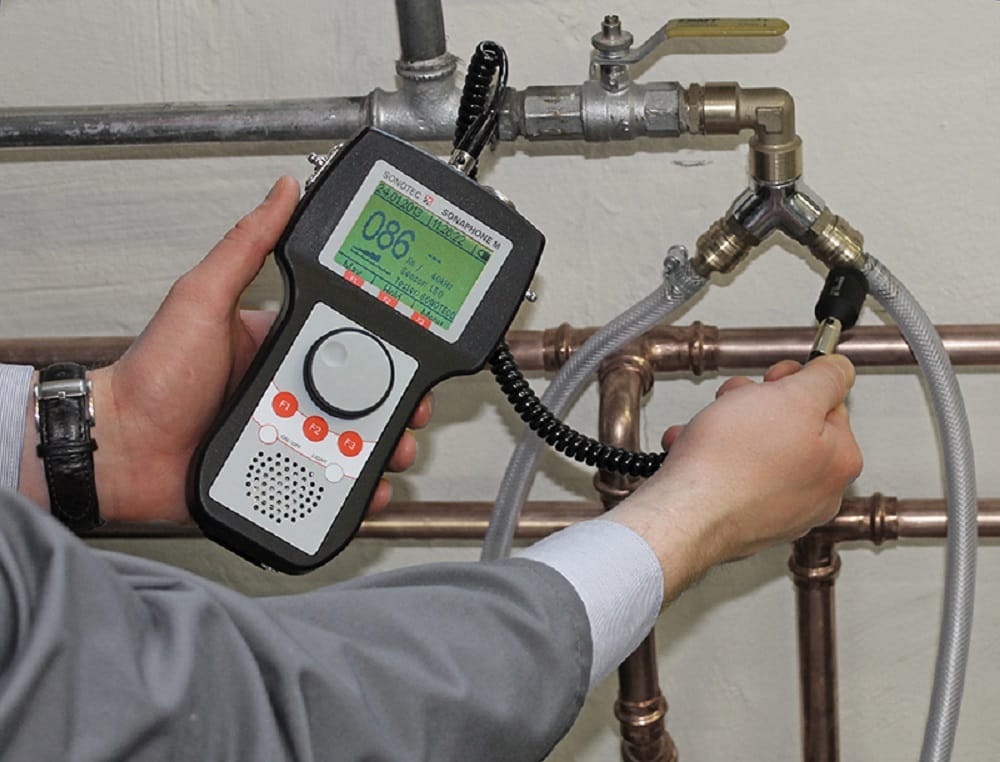 Plumber testing pipes with electronic leak detection equipment in Marina