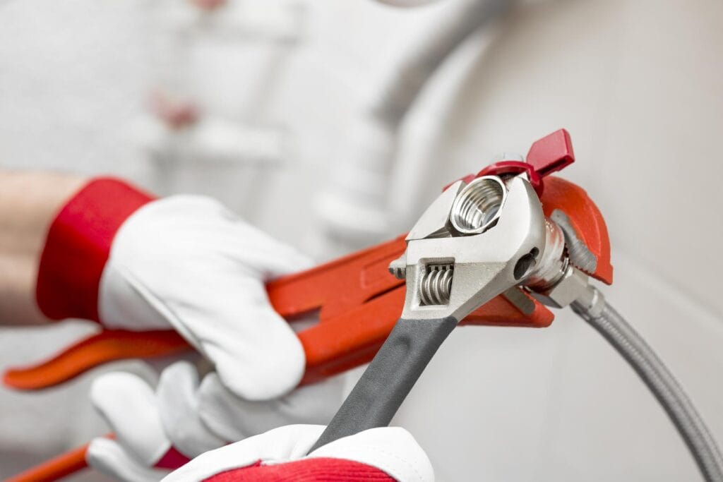 Plumber holding pipe wrenches for an emergency repair in Marina