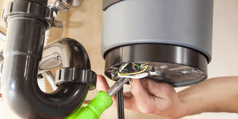 Technician repairing the heating element of a water heater in Marina
