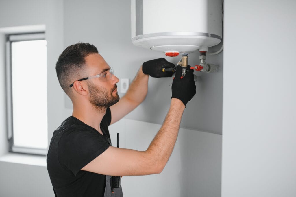 Technician performing water heater maintenance in Marina